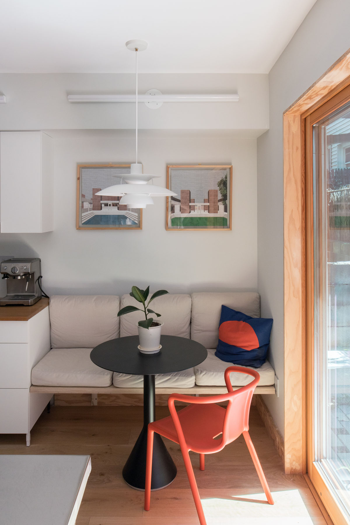 Manhattan townhouse dining nook with modern furniture and framed architectural artwork by Rauch Architecture.