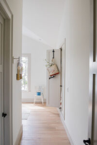 Hallway with natural light and simple decor in Rauch Architecture home.