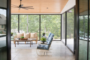 Screened-in porch with forest and lake views, designed by Rauch Architecture.