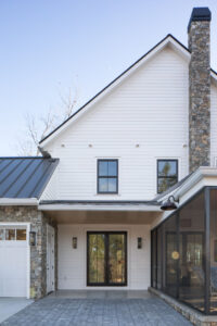 Rauch Architecture lake house with stone chimney and entryway.