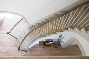 Curved staircase with shaker-style balusters in Rauch Architecture home.