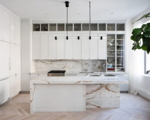 White slim shaker kitchen cabinets with glass in a Chelsea, NYC duplex renovation by Rauch Architecture.